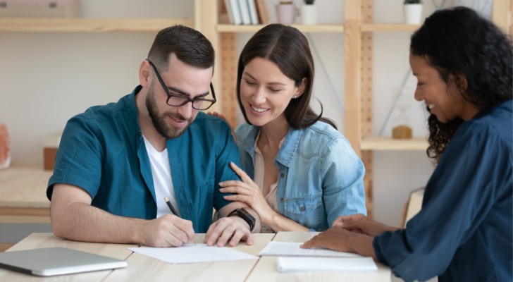 A couple signing the paperwork to be a successor beneficiary