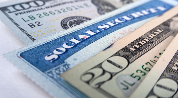 A Social Security card sandwiched between cash.