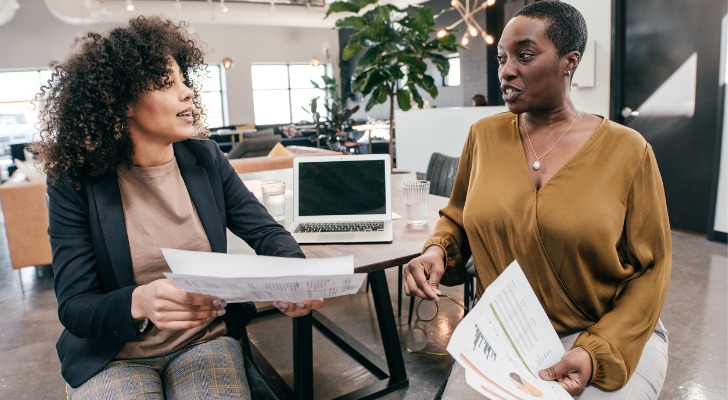 Two women discussing potential cash out penalties of their 401(k)