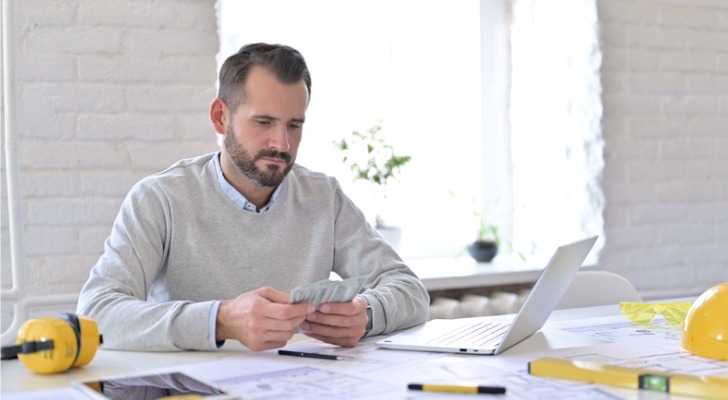 A financial advisor looking through the participation rate of his clients' annuities at their office.