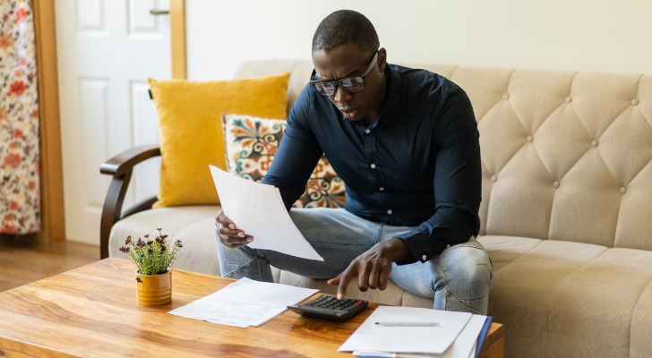 A man calculates how much money he could contribute to a Roth IRA.