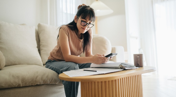 A woman researching the differences between earned and unearned income.