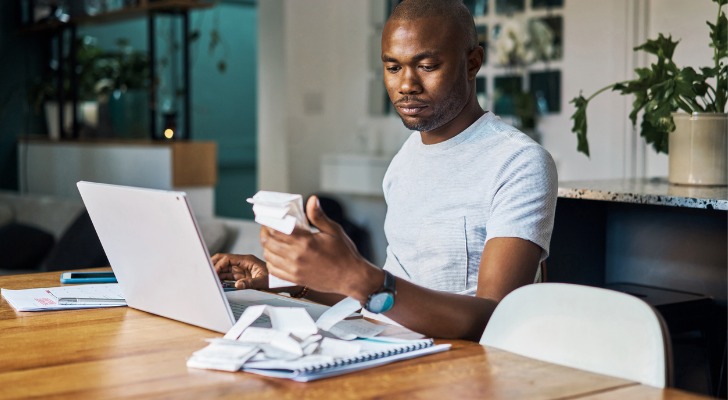A man adding up investment fees from his retirement account.