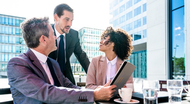 Financial advisors reviewing Medicare savings program options for clients.