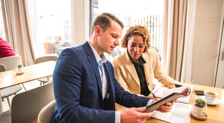 Two financial advisors negotiating the sale of a book of business.