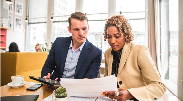 Business partners meet to discuss errors and omissions insurance policies