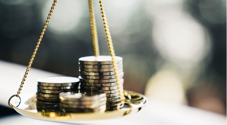 Coins stacked on a balance scale.