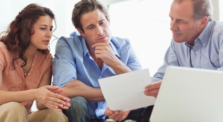 A couple meets with a financial advisor to go over tax mitigation strategies.