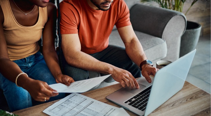 A couple reviewing their earned and unearned income to file taxes.