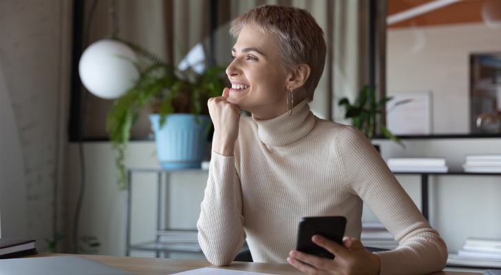 A woman celebrating that she is close to reaching her long-term goals.