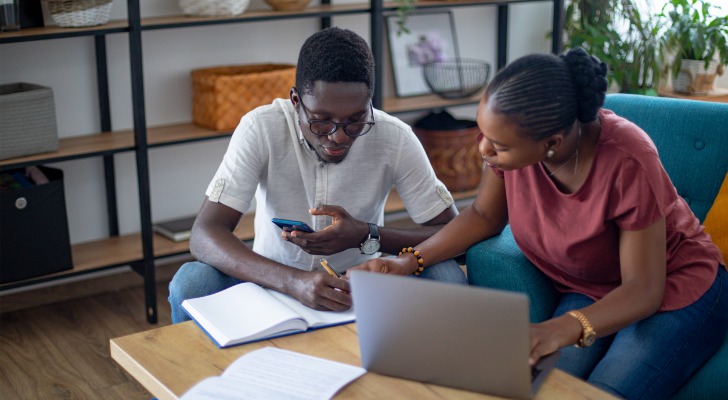 A couple calculating how much they will have to pay in taxes from unearned income.