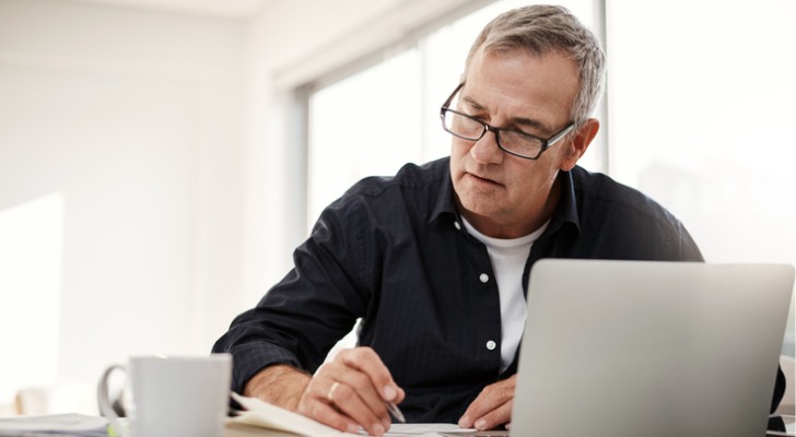 A man looks over the paperwork for a fixed annuity that he's considering.