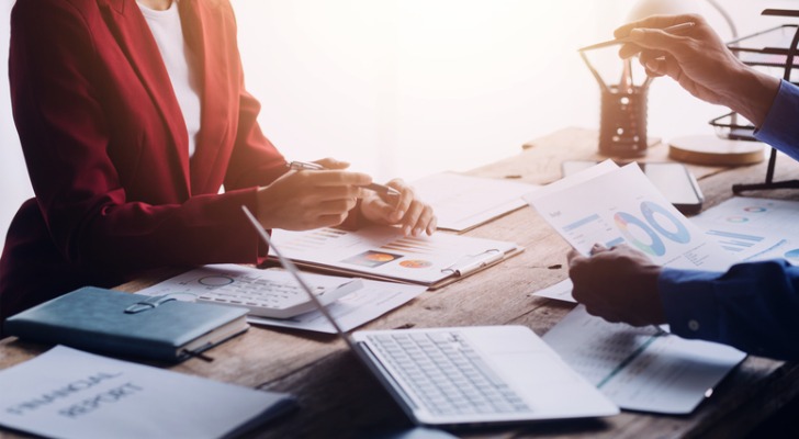 Two financial analysts comparing a portfolio's performance with TWR and IRR.