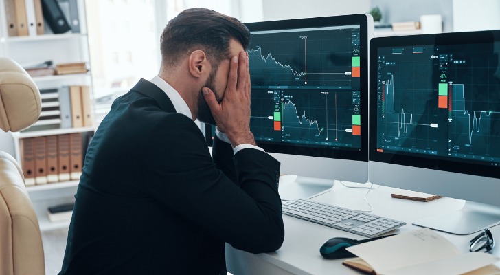 An investor under stress from market volatility and risk.
