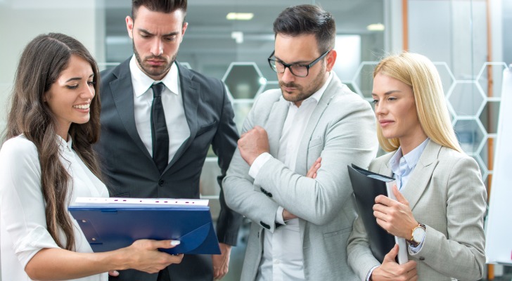 Financial advisors reviewing different tax-advantaged investments.