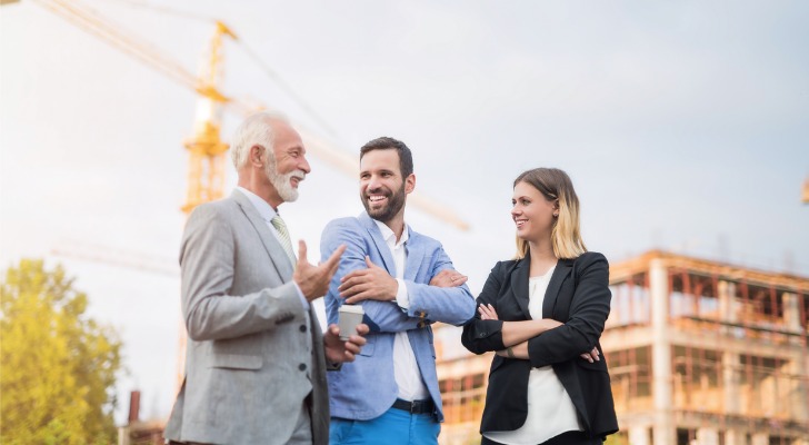 Three partners in a real estate limited partnership (RELP) overlook construction on a project they are investing in