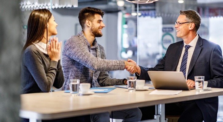 An RIA meeting with clients to help them manage their real estate investments.