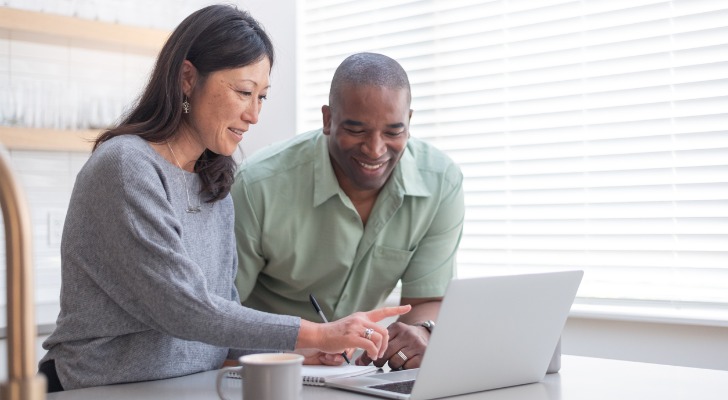 A married couple looks over their traditional and Roth IRAs.
