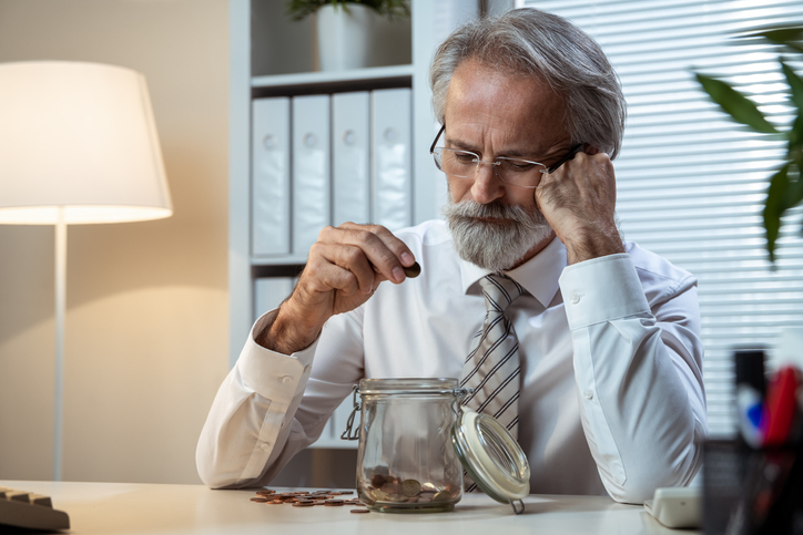A retiree counting change while contemplating whether he should unretire.