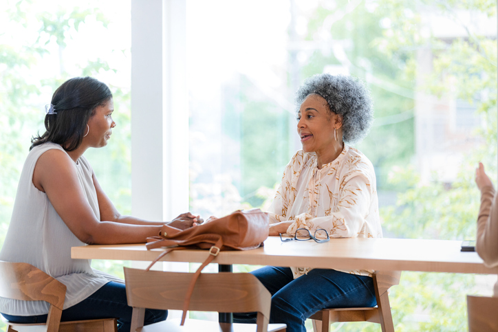 A mother and daughter going over the details of a will.