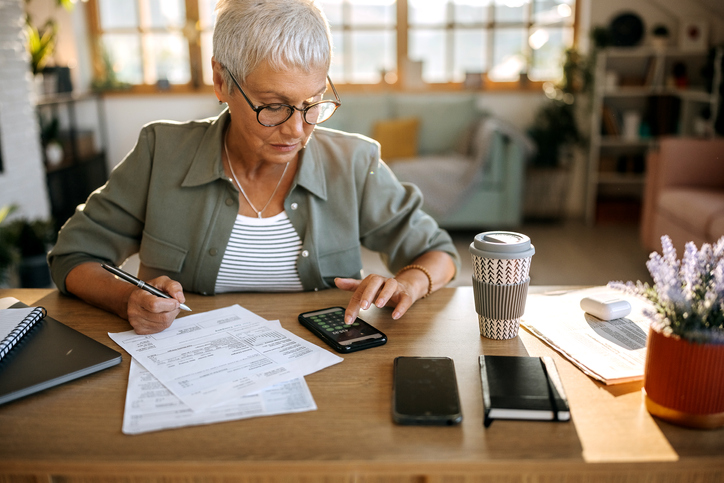 A woman calculating how much she has saved for retirement.