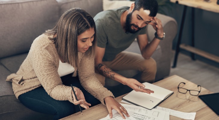 A couple adding up their sources of unearned and earned income for the tax year.