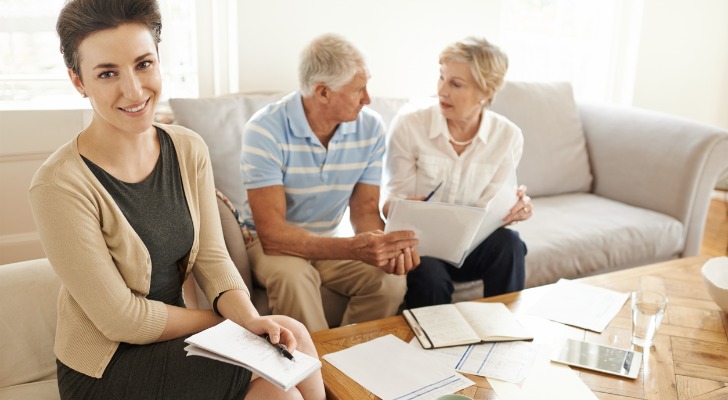 Clients meeting with a financial advisor to review the costs of opening an IRA.