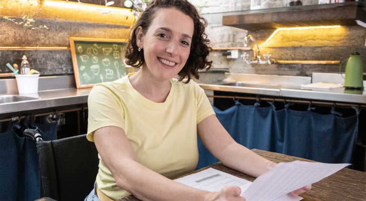 A woman reviewing how much money she can make to qualify for SSI.