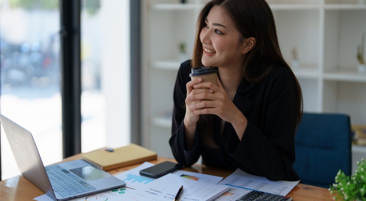 A woman looking back on how much progress she is making to reach her long-term financial goals.
