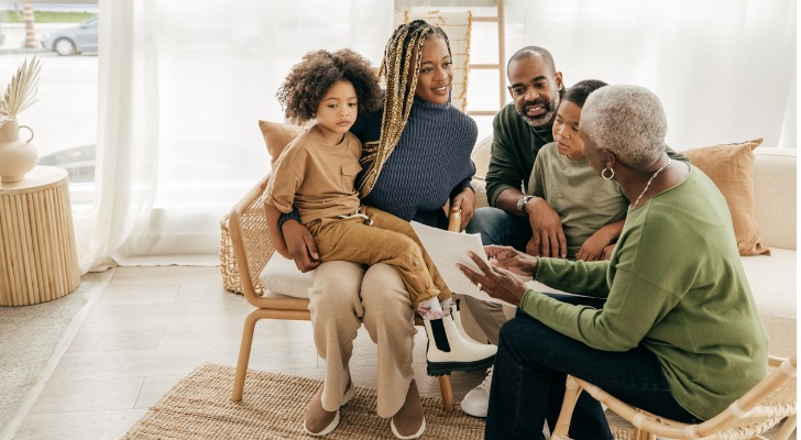 A woman goes over her estate plan with her daughter, son-in-law and grandchildren.