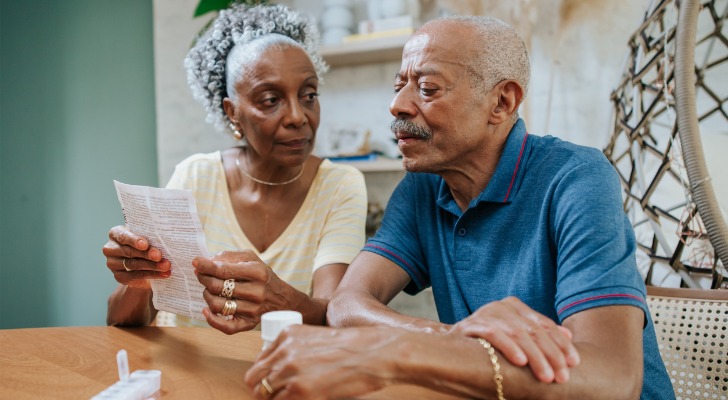 A senior couple reviewing how much Medicare Part B will cover.