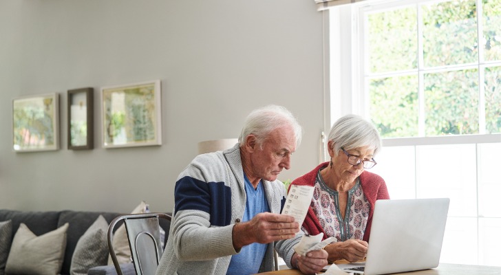 A senior couple reviews how much they are paying for an IRA.