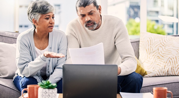 A couple reviewing a one-page financial plan template from an advisor