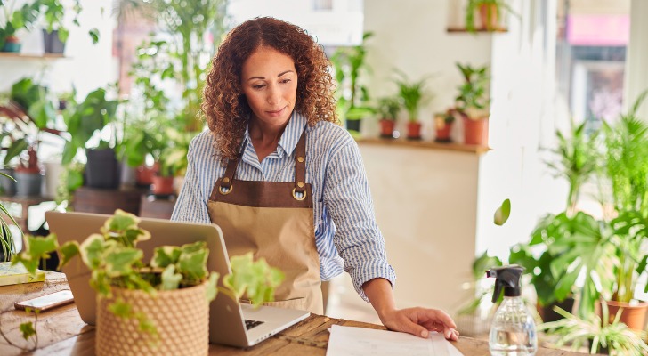 A florist looks over her retirement savings in her solo 401(k).