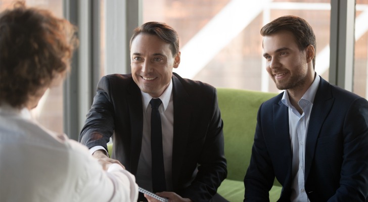 Two financial advisor interviewing a candidate for an internship.