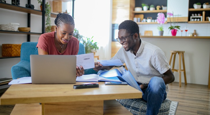 A couple researching the requirements to open a Roth IRA.