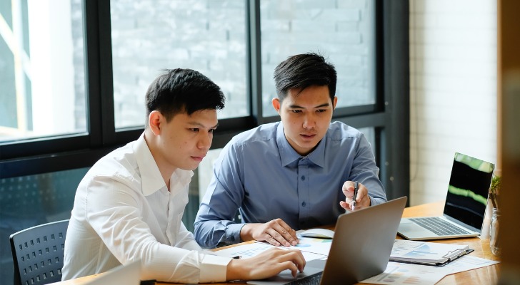Financial advisors going over statistics about their industry.
