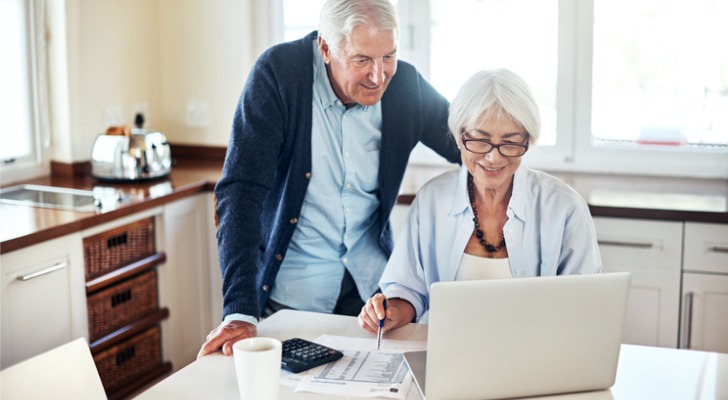 A senior couple looking at their Social Security benefit increase after reaching retirement age.