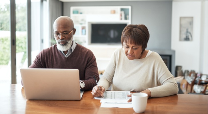 Two seniors reviewing how their REIT investments are performing.