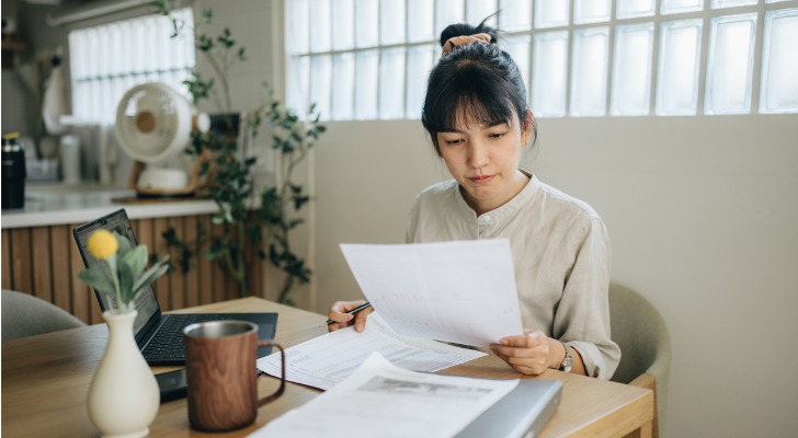 A woman reviews an attorney's bill to determine whether her legal fees are tax deductible.
