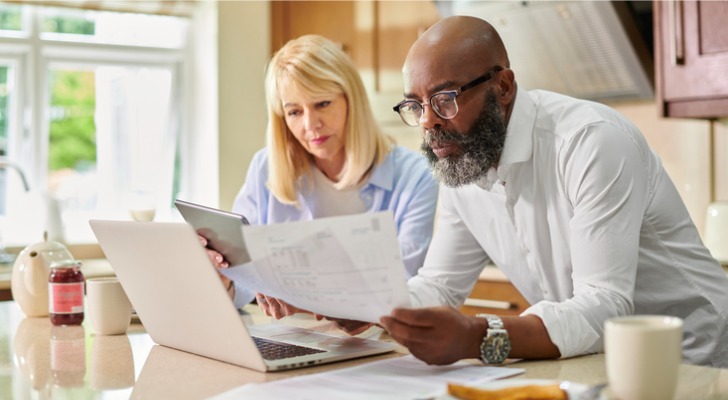 A married couple looks over their IRA accounts as they calculate taxes on a Roth conversion.