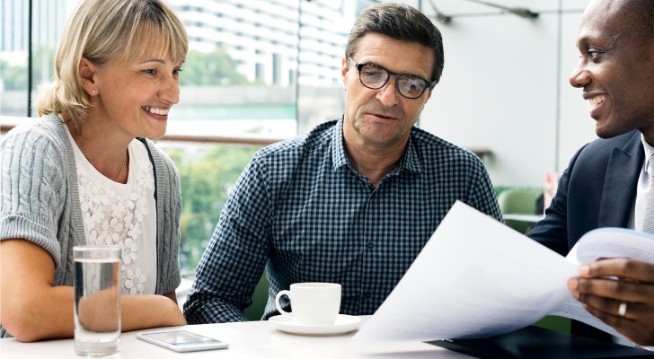 A senior couple meeting with a financial advisor to better understand their IRA basis.