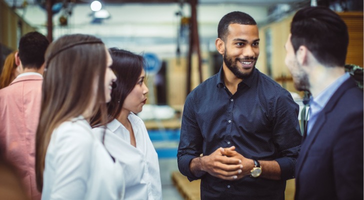 A financial advisor engaging with target clients at a marketing seminar.