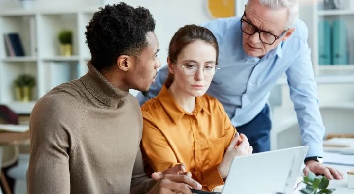 A couple meeting with a financial advisor to discuss the benefits and drawbacks of a Lady Bird deed for their property in Florida.