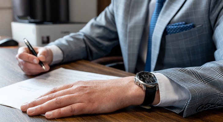 A man fills out Form DE-221 to file a spousal property petition in California.