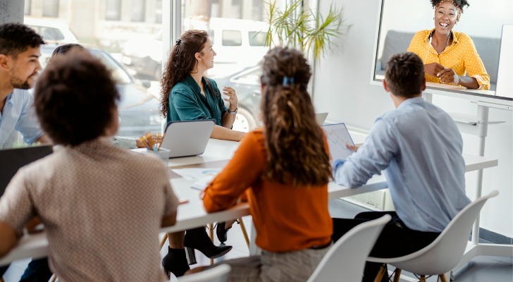 Financial advisors setting up a marketing seminar for target clients.