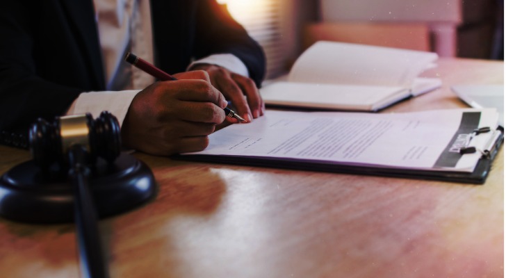 A judge reviews paperwork for probate in New York.