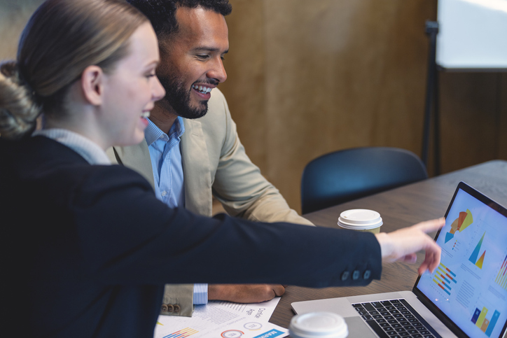 Two financial advisors work with estate planning software.