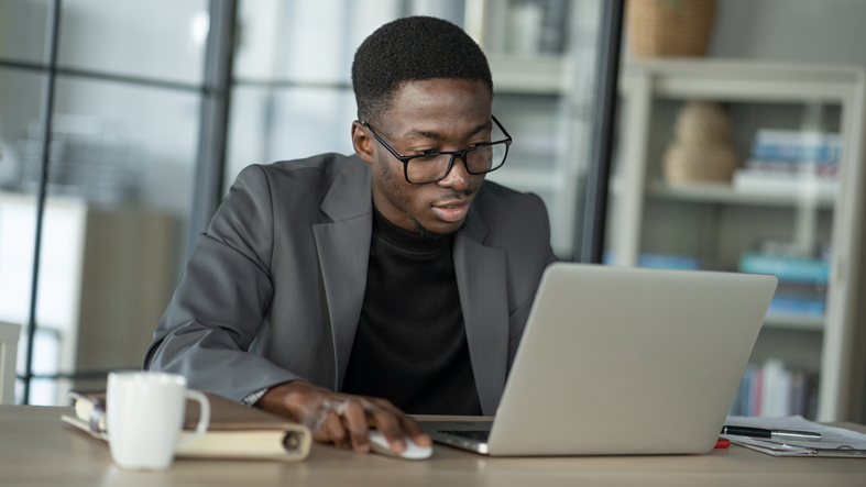 A man researching the requirements for a financial advisor development program.