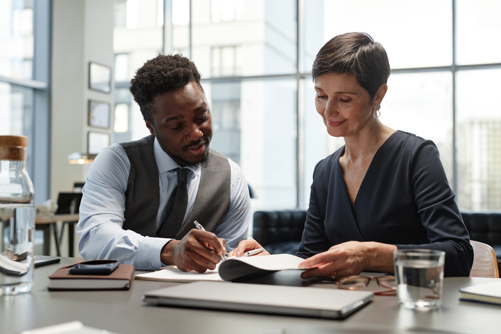 Two financial advisors reviewing a content marketing strategy to connect with new potential clients.